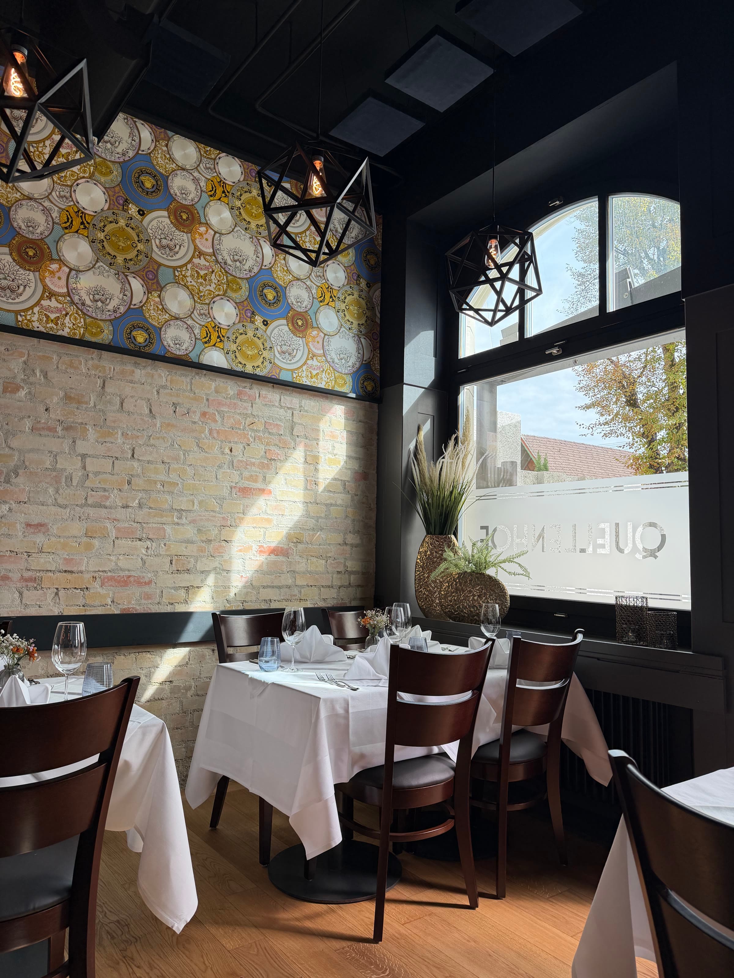 A corner table against the brick wall under the plate wall