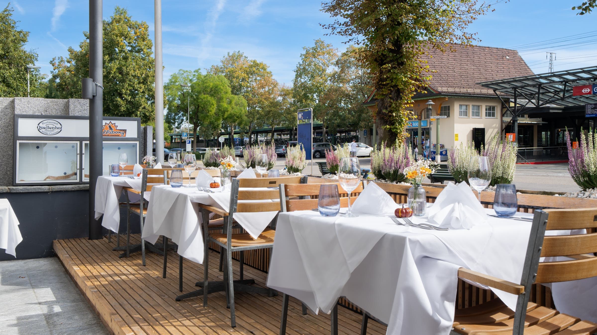 The terrace on its decking, tables laid on a bright day